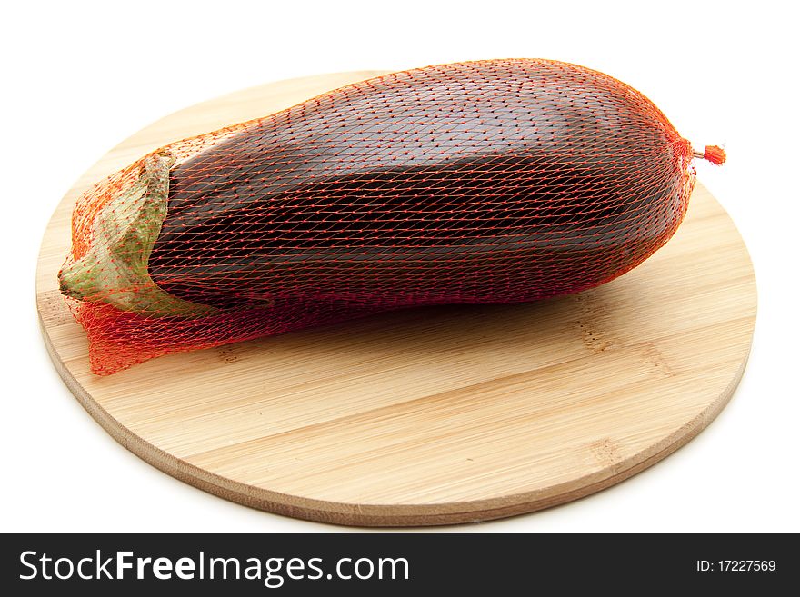 Aubergine in the net and onto wood plates