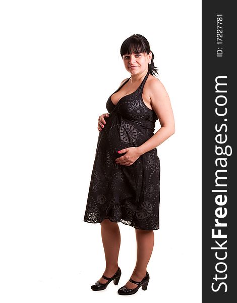 Pregnant woman in black dress on white background