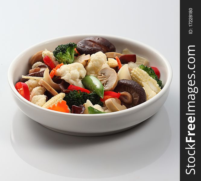 A bowl of oriental stir-fried vegetable with mushroom. A bowl of oriental stir-fried vegetable with mushroom