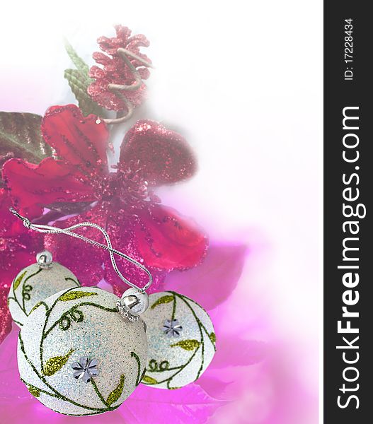 Christmas balls and red flower on white background