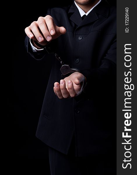 Business man in black suit and handcuffs. Business man in black suit and handcuffs