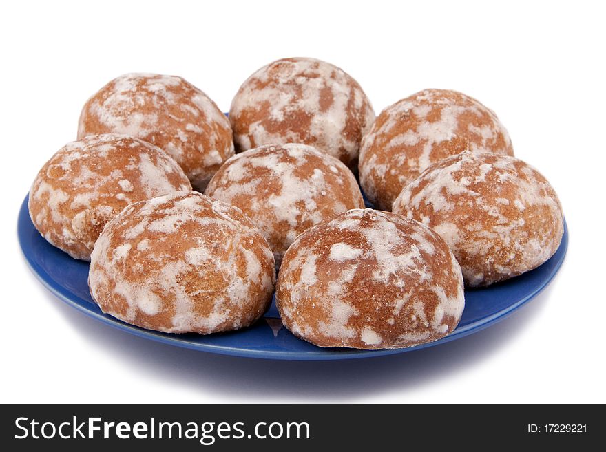 The glazed spice-cakes on a dark blue saucer