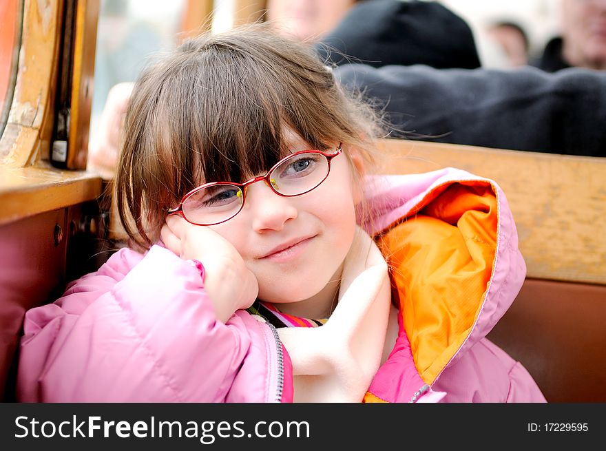 Small girl in winter clothes in old style train