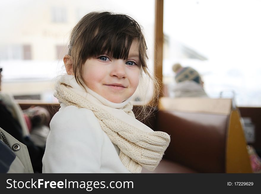 Adorable small girl in winter clothes in old style mountain train. Adorable small girl in winter clothes in old style mountain train