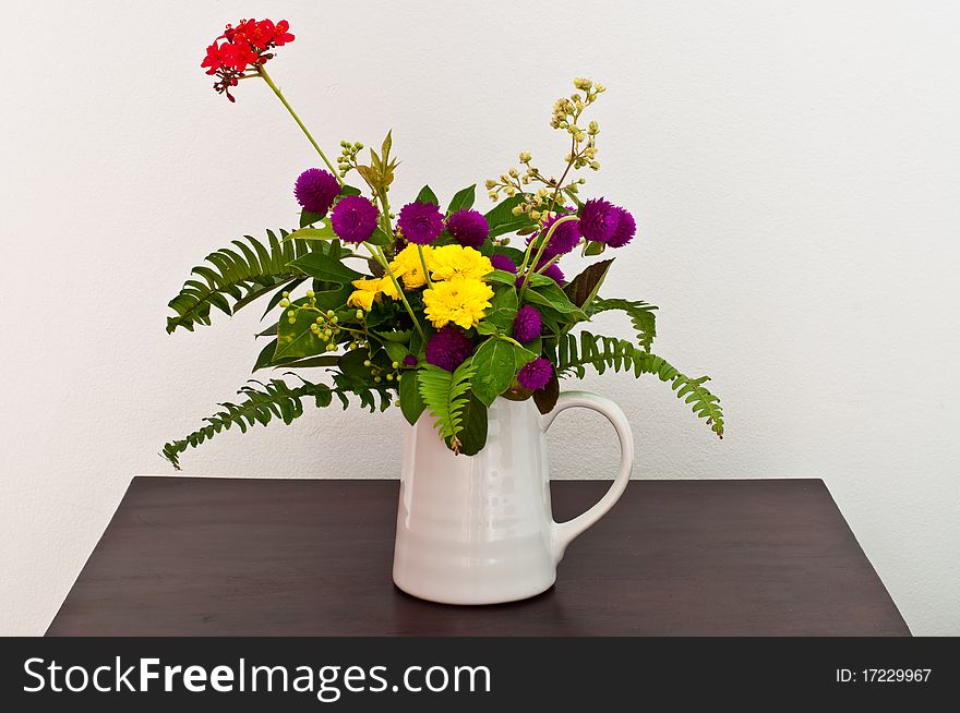 Colorful flowers in white cup