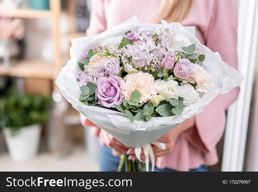 Beautiful bouquet in womans hands. the work of the florist at a flower shop. Delivery fresh cut flower. European floral