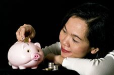 Young Woman With Pink Piggy Bank Royalty Free Stock Image