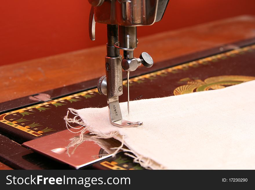 Ancient sewing machine needle and linen cloth