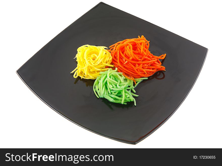 Grated vegetables in a black plate. Grated vegetables in a black plate