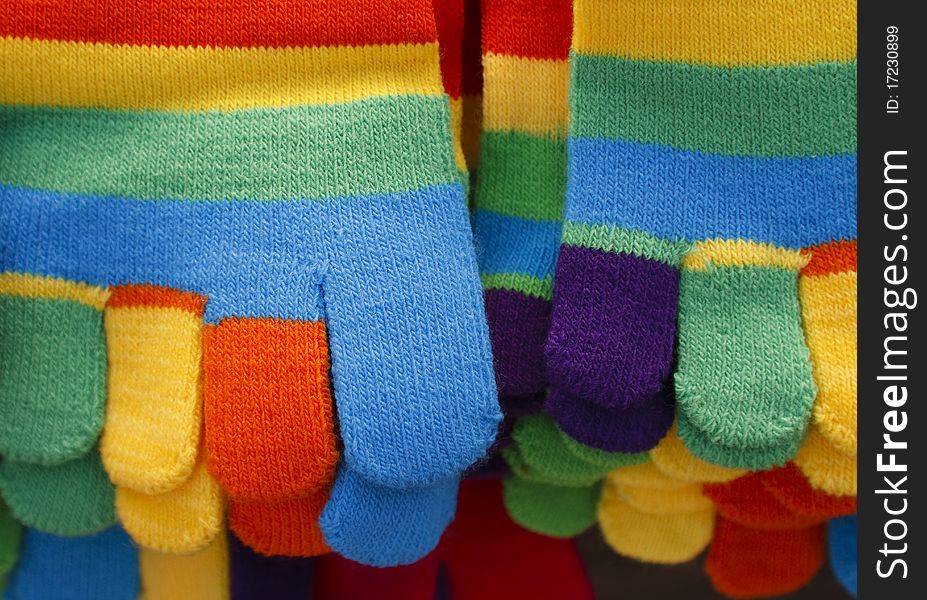 Knitted striped winter gloves in bright colors