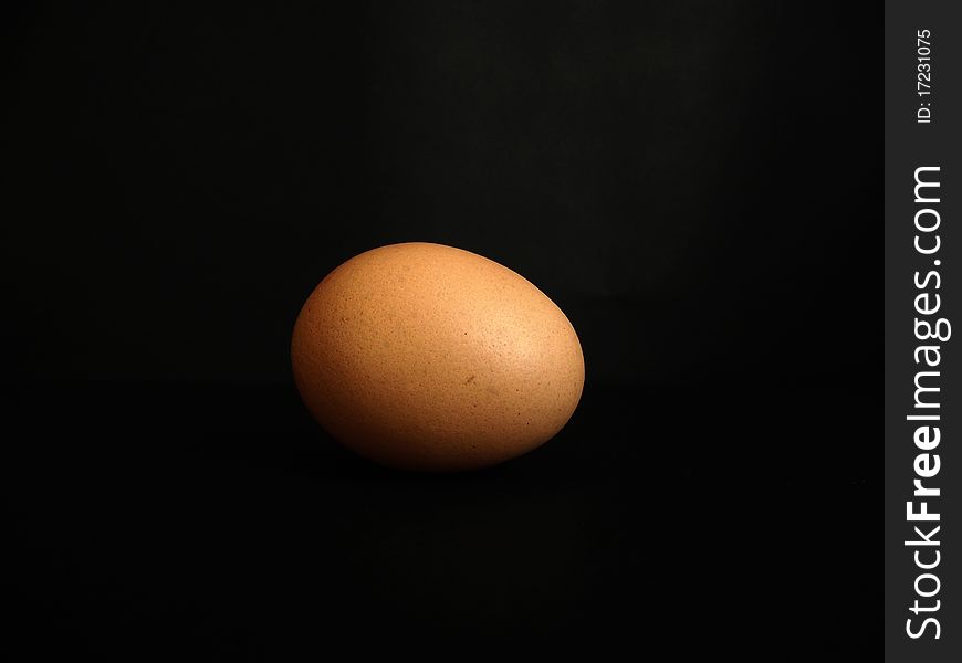 One egg on a black background