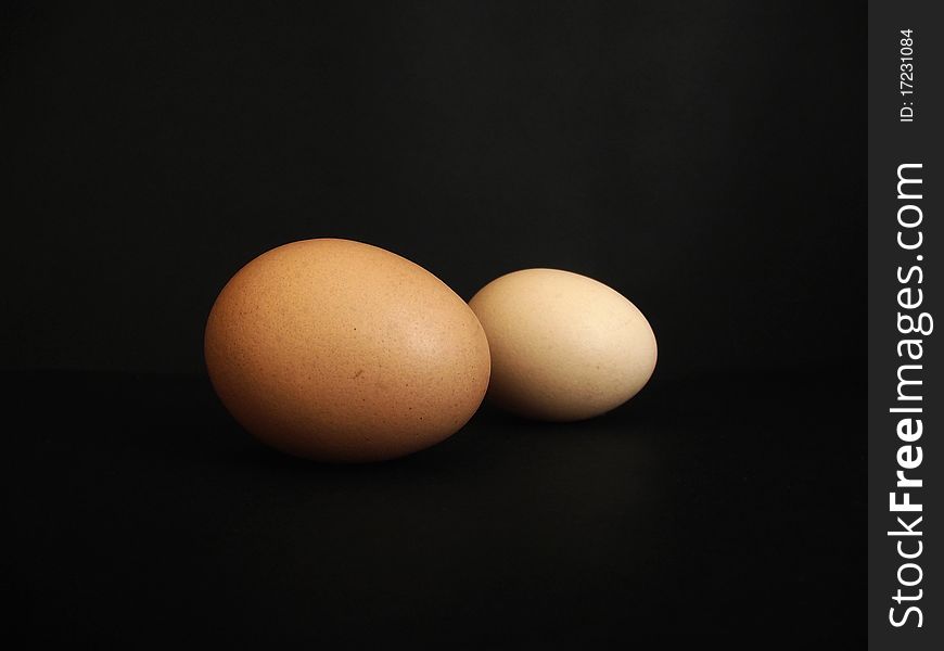 Two eggs on a black background