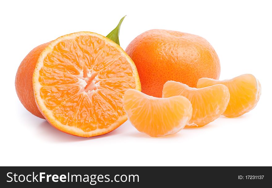 Ripe tangerines with leaves and slices on white background