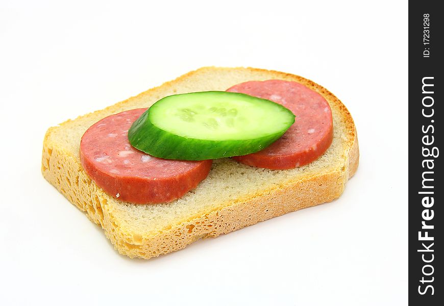 Sandwich with sausage and a cucumber