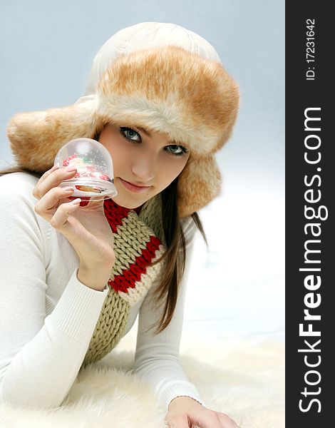 Young caucasian woman with christmas toy in fluffy hat