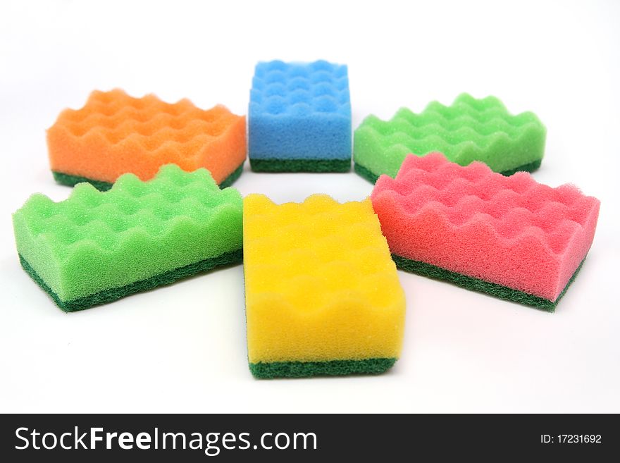 Close-up of bright-colored sponges for cleaning and home care - isolated on white background. Close-up of bright-colored sponges for cleaning and home care - isolated on white background