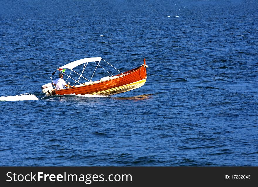 Motor boat in the blue water of the lake