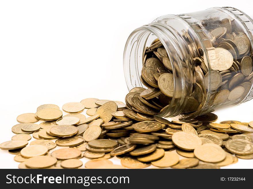 Ukrainian coins spill abundantly from glass banks on white background closeup