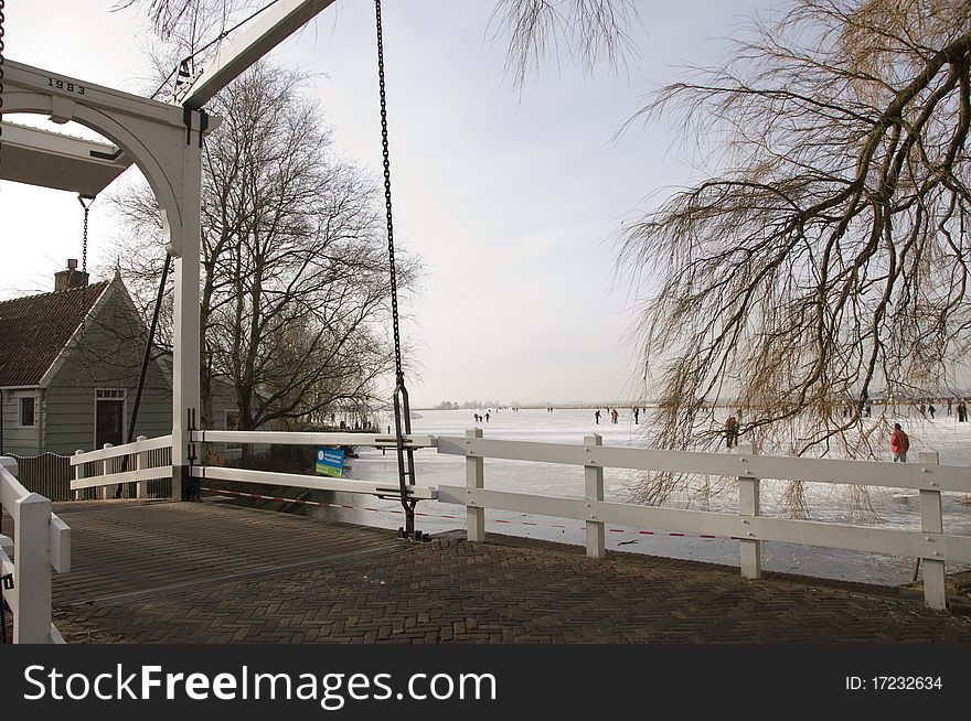 Drawbridge in a little village with skaters on a distance. Drawbridge in a little village with skaters on a distance