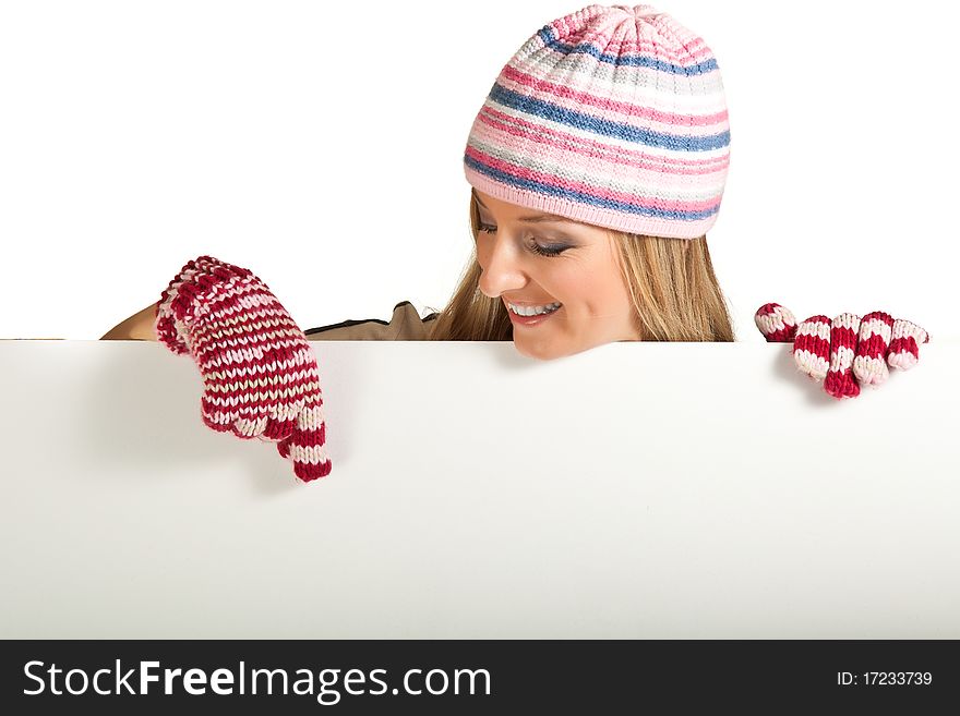 Woman in colorful hat and gloves peeping from behind whiteboard isolated on white. Woman in colorful hat and gloves peeping from behind whiteboard isolated on white