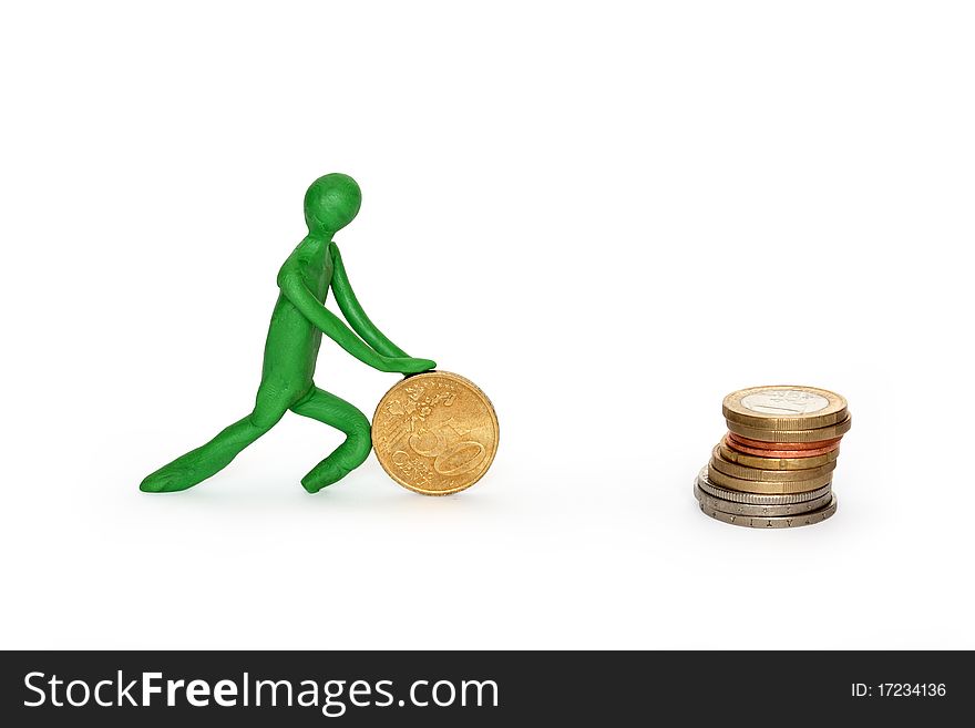 Green plasticine man rolling coin to stack of coins. Isolated on white with clipping path. Green plasticine man rolling coin to stack of coins. Isolated on white with clipping path