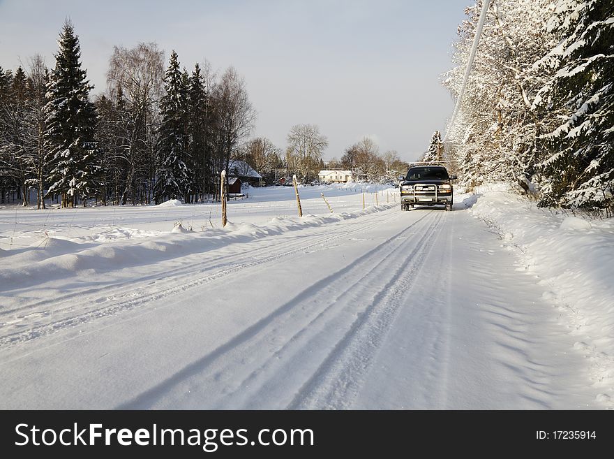 Large suv, driving on small snowy road through a swedish winter scenery. smaland, sweden. Large suv, driving on small snowy road through a swedish winter scenery. smaland, sweden