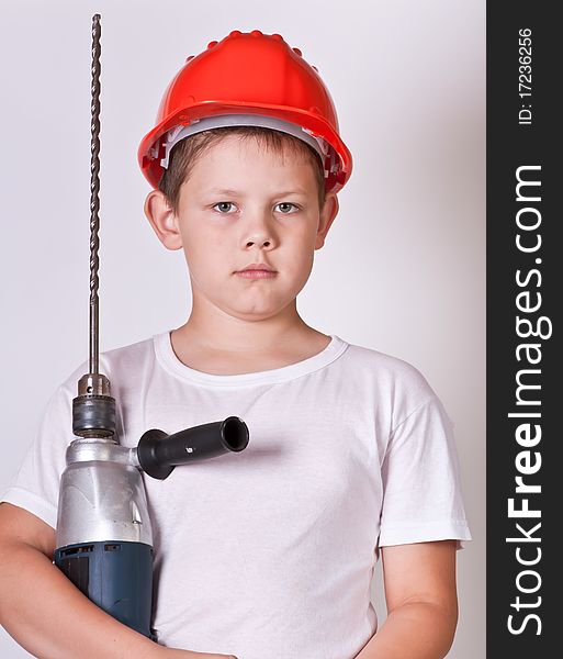 Portrait of a boy in a red protective helmet