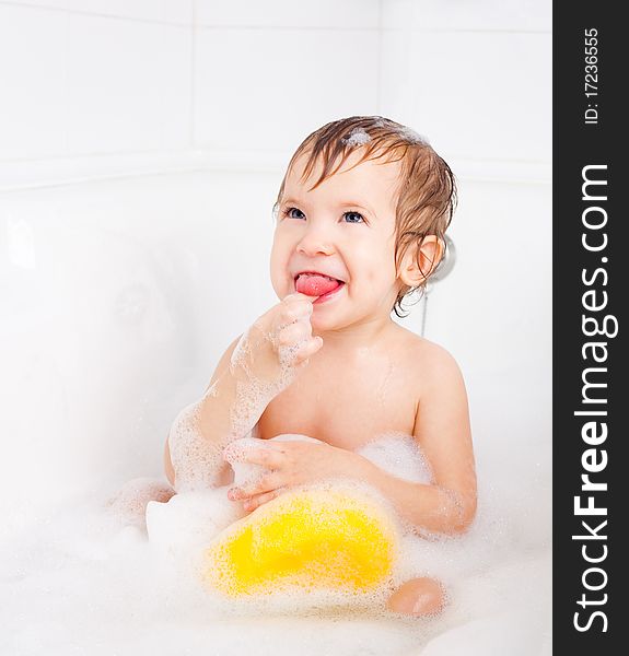 Beautiful little boy taking a relaxing bath with foam. Beautiful little boy taking a relaxing bath with foam