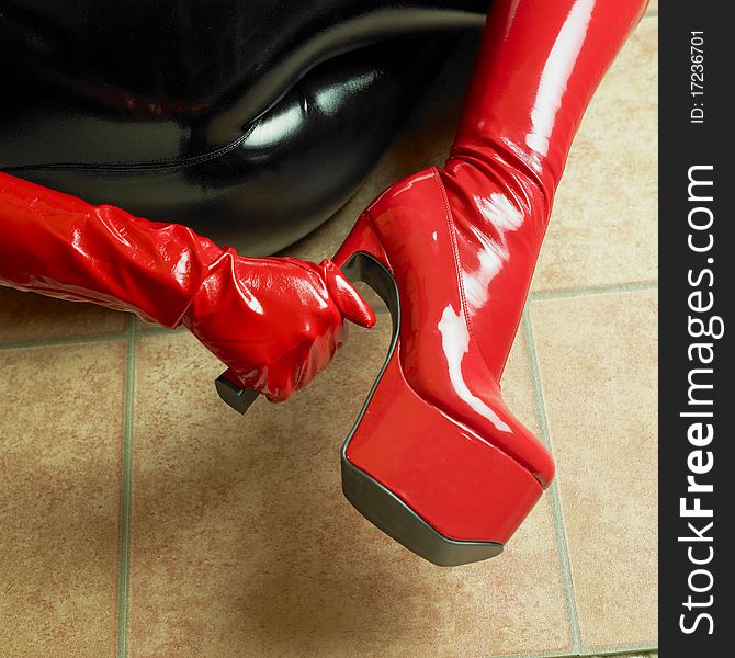 Detail of red latex boots