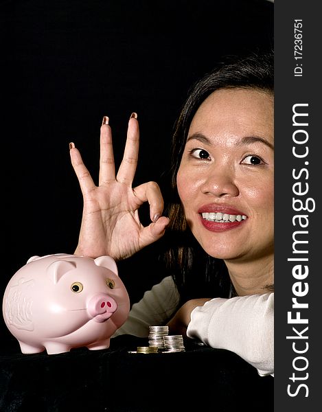 Young woman with pink piggy bank