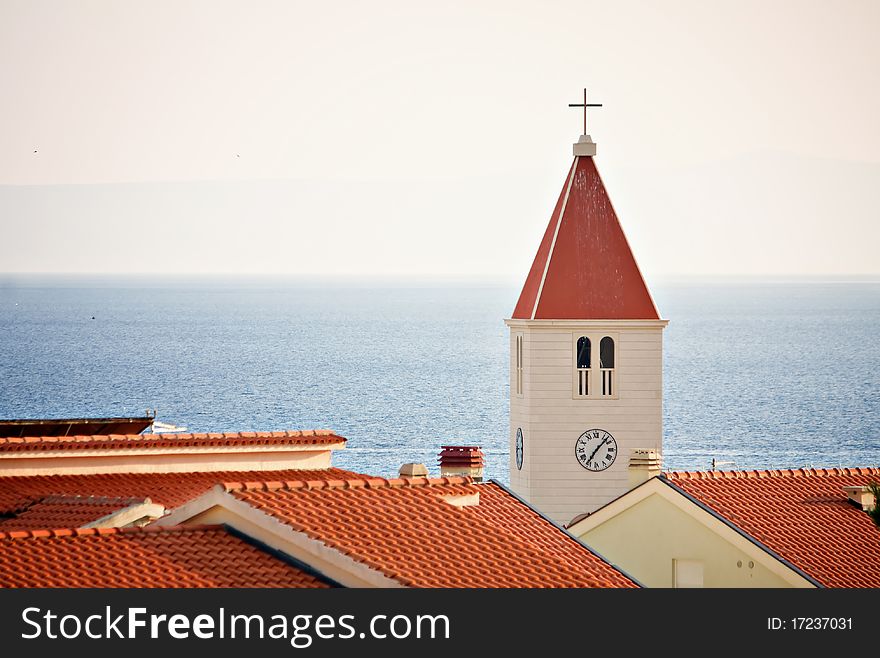 Chatolic church over roofs at sea.