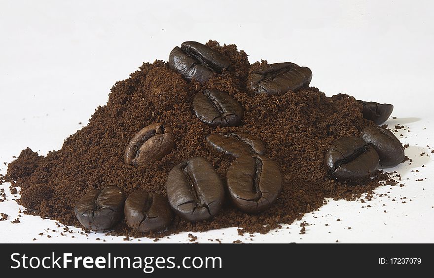 Lines with beans on coffee powder of the famous drink