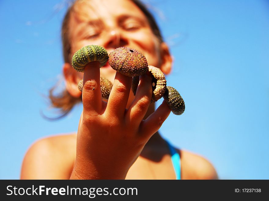 Little girl portrait with sea urchin shell