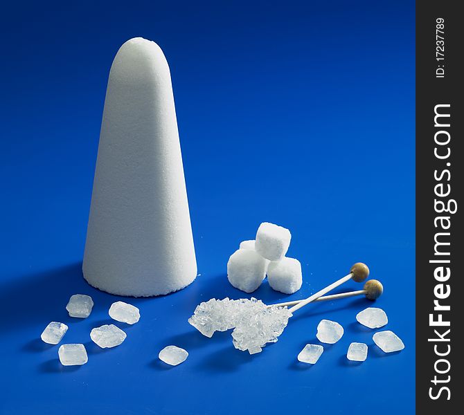 Still life of sugar on blue background