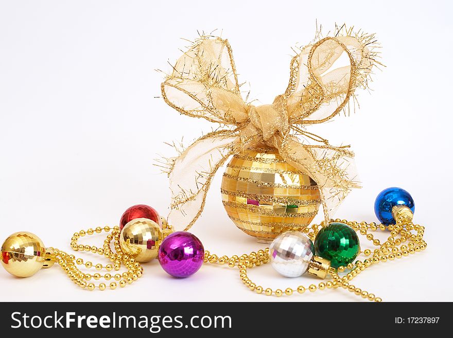 Gold Christmas bauble with colorful small balls on white background with copy space. Gold Christmas bauble with colorful small balls on white background with copy space.