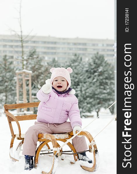 Little girl sledding in snow