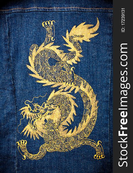 Gold dragon painted on blue jean jacket