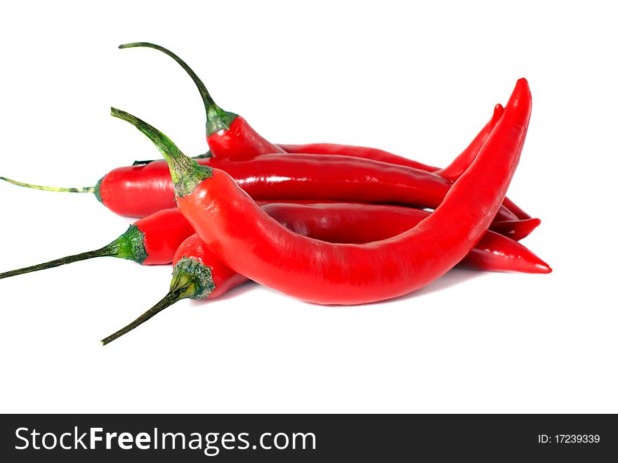 A handful of chili peppers on a white background