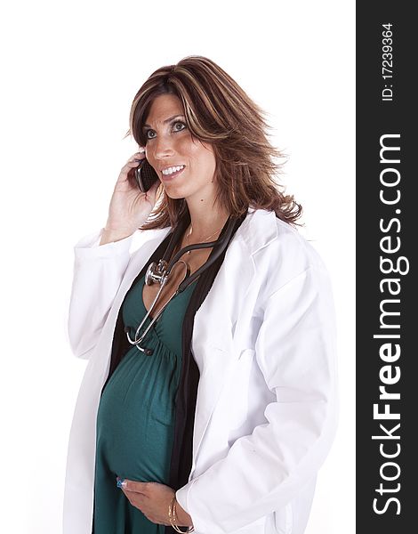 A woman doctor talking on her cell phone while she holds her belly. A woman doctor talking on her cell phone while she holds her belly.