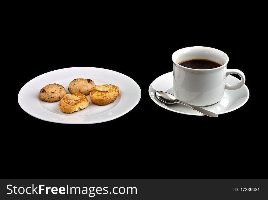 Black coffee in a white coffee cup with biscuit on plate. Black coffee in a white coffee cup with biscuit on plate