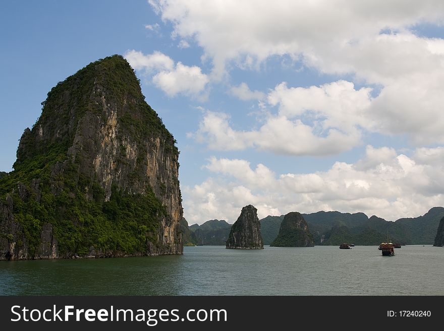 Rock cliffs rise out of the ocean in Halong Bay, Vietnam. Rock cliffs rise out of the ocean in Halong Bay, Vietnam