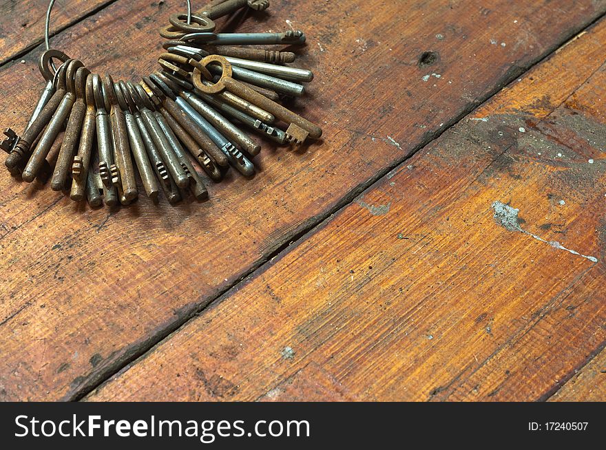 Antique steel keys on old wooden background. Antique steel keys on old wooden background