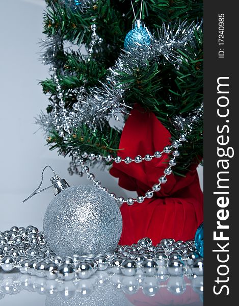 Christmas tree, white background, silver ball on the front. Christmas tree, white background, silver ball on the front