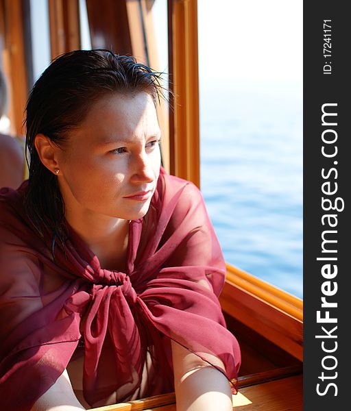 Woman looking trough window on the sea. Woman looking trough window on the sea