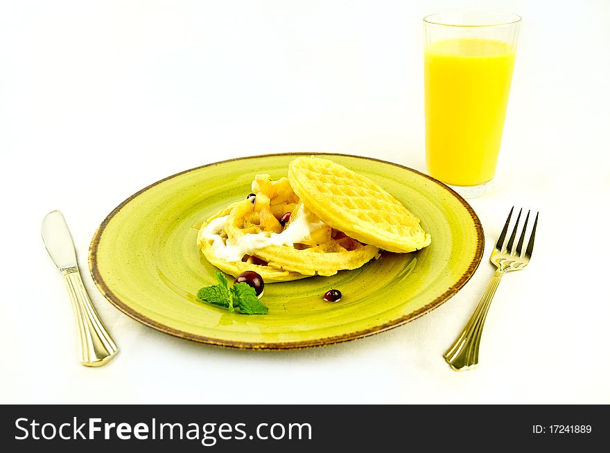 Waffles breakfast with orange juice on a white buckground