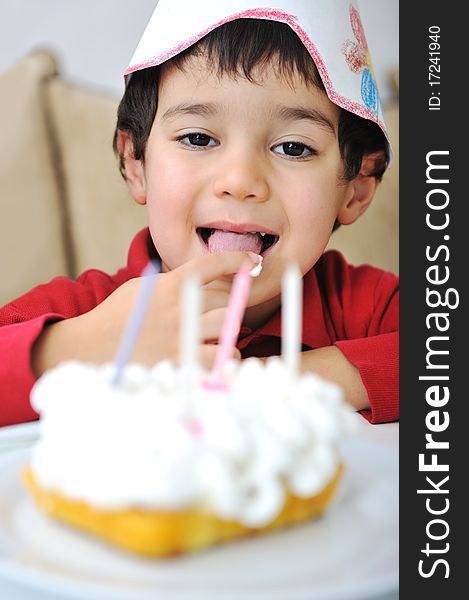 Little cute kid and his birthday cake