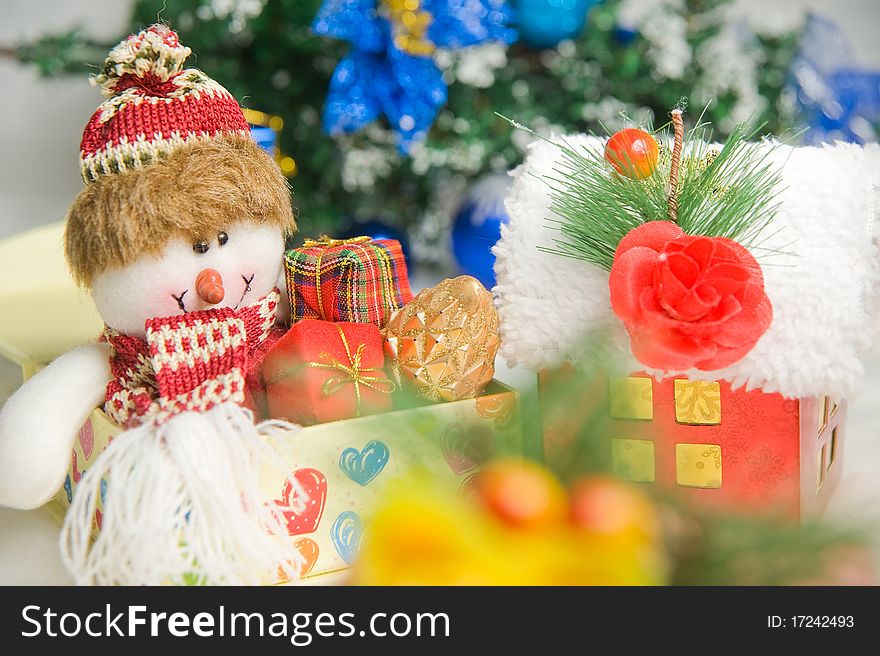 Christmas greeting Santa with gifts front of a christmas tree