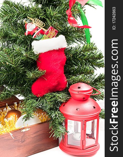 Christmas-tree decorations against a green fur-tree with a red lantern