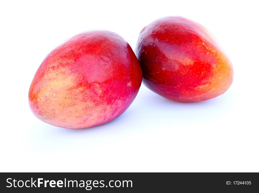 Two ripe mangos isolated on white background.