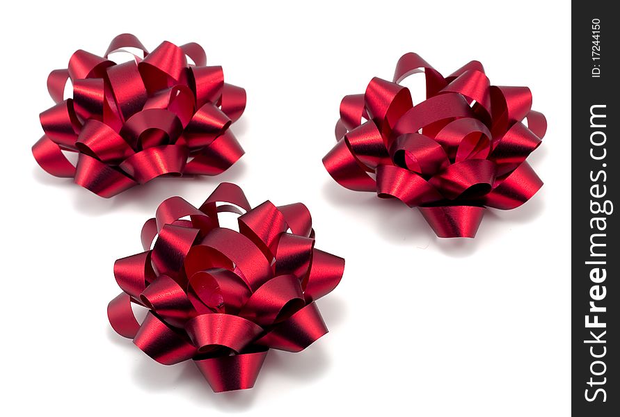 Studio shot of three red christmas bows on white background